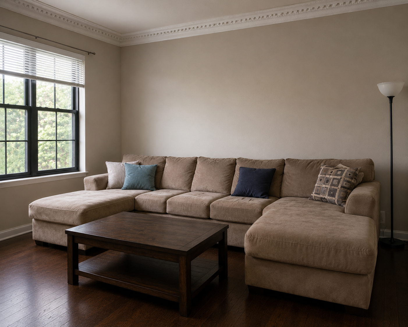 Plain greige living room before Art Deco makeover with basic tan sectional and no personality